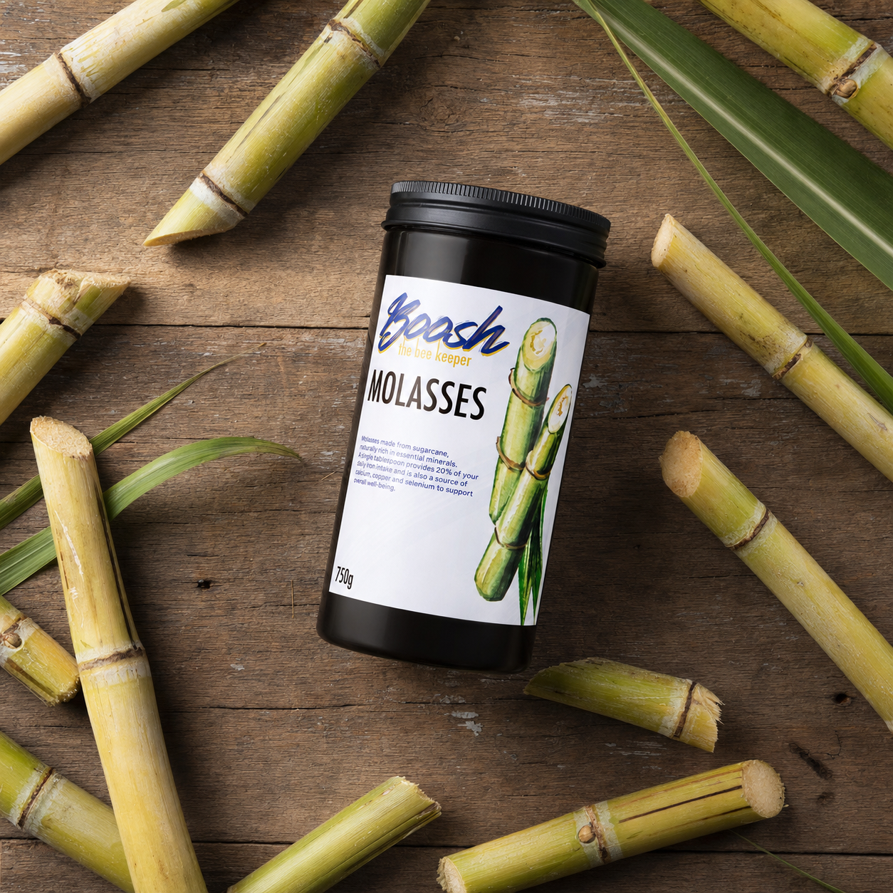 Boosh the Beekeeper unsulphured molasses, dark and glossy, surrounded by fresh sugarcane